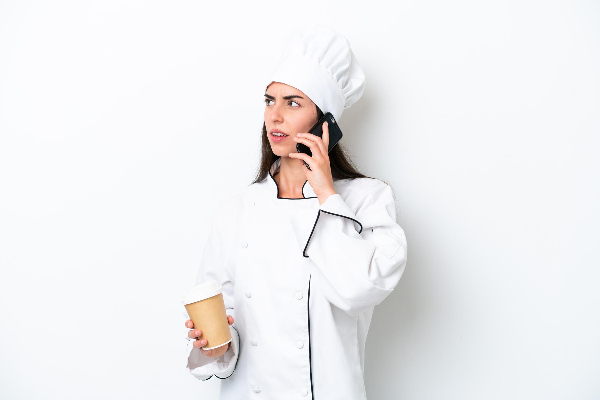 Chef answering phone in small kitchen